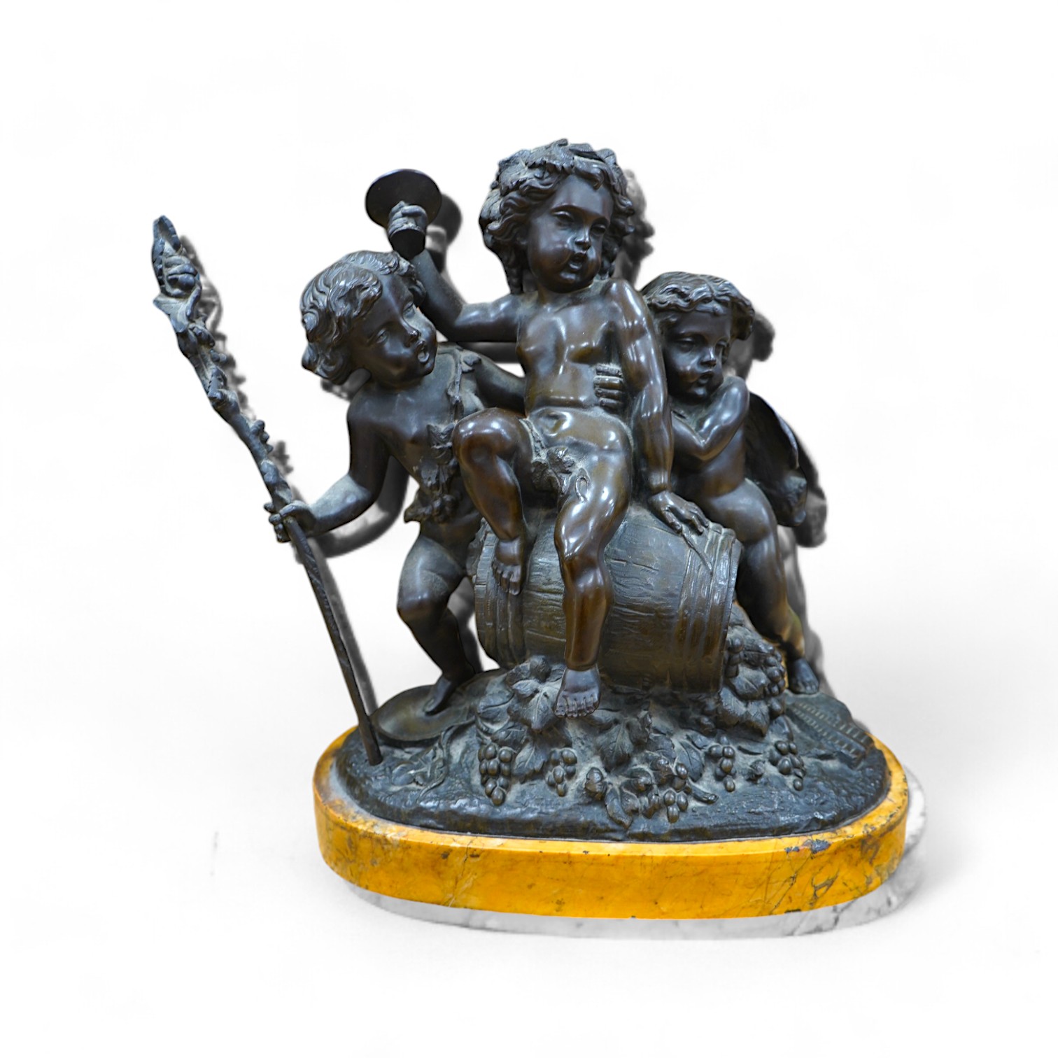 After Claude Michel Clodion (1738-1814), a bronze group of three Bacchanalian cherubs on sienna marble base, 31cm. Condition- fair to good